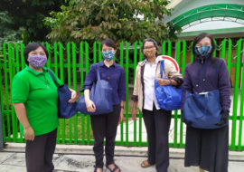 FCJ sisters in Yogyakarta Indonesia delivering gifts to neighbours for Idul Fitri