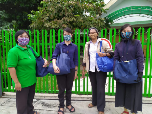 FCJ sisters in Yogyakarta Indonesia delivering gifts to neighbours for Idul Fitri